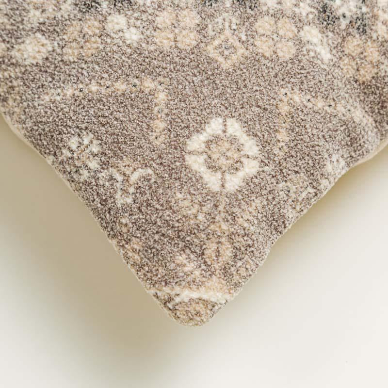 Corner close-up of a piece of the Badami Cushion, a square accent pillow with ethnic prints you can buy online at Sukham Home, a sustainable furniture, kitchen & dining and home decor store in Kolkata, India.