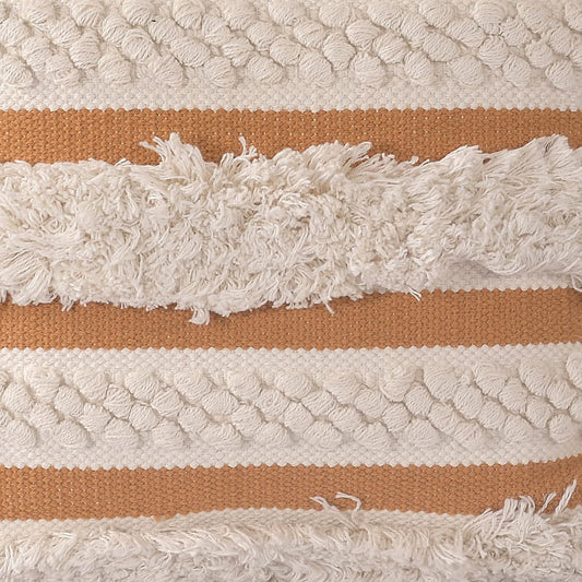 Closeup of the Chunky Hazelnut Cushion, a square accent pillow with fringes and knots and a delightful yellow tone which you can buy online at Sukham Home, a sustainable furniture, kitchen & dining and home decor store in Kolkata, India.