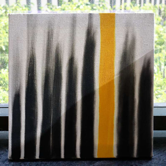 Placed by a window, The Light I Seek painting, a yellow, black and white canvas artwork you can buy online at Sukham Home, a sustainable furniture, kitchen & dining and home decor store in Kolkata, India