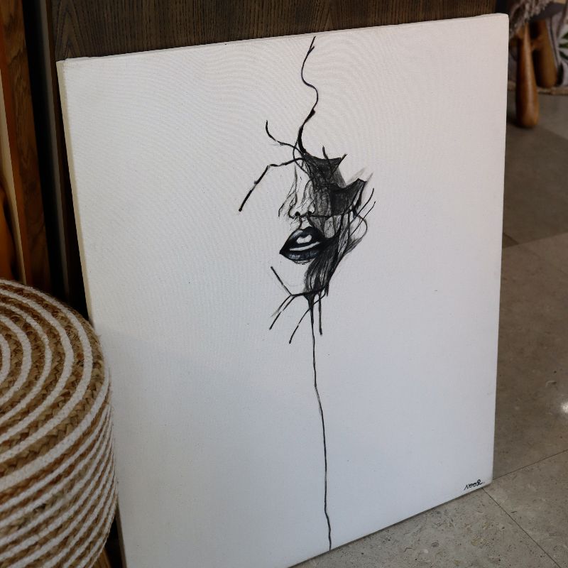 Set on the floor, the Face of Courage painting, a black and white canvas artwork you can buy online at Sukham Home, a sustainable furniture, kitchen & dining and home decor store in Kolkata, India