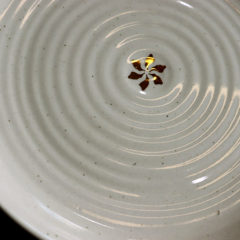 Close up of the gold flakes on the Beige Ganga Dinner Plate - a beige and 24-karat gold ceramic plate you can buy online at Sukham Home, a sustainable furniture, gardening and home decor store in Kolkata, India