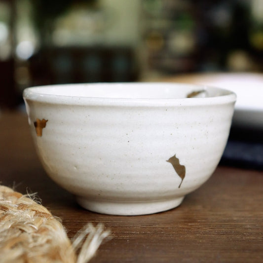 Close up of the texture and gold flakes on the Beige Ganga Small Bowl, an off-white and 24-karat gold ceramic small bowl you can buy online at Sukham Home, a sustainable furniture, gardening and home decor store in Kolkata, India