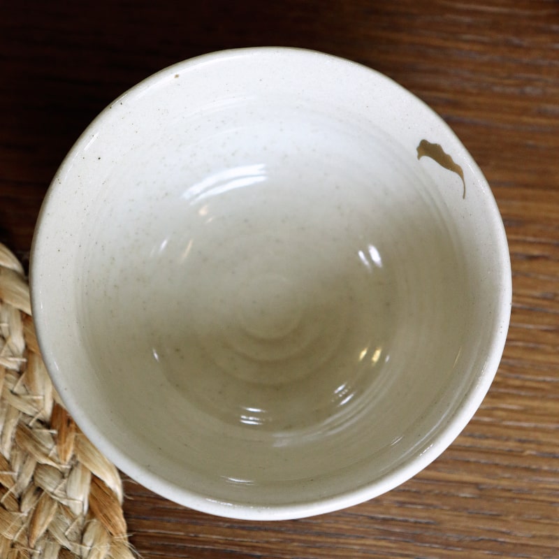 Top view of the Beige Ganga Small Bowl, an off-white and 24-karat gold ceramic small bowl you can buy online at Sukham Home, a sustainable furniture, gardening and home decor store in Kolkata, India