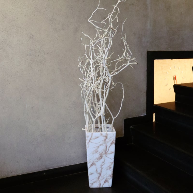 In White Italian Marble finish, the Cubico, a large square tall textured luxury planter made from FRP you can buy online at Sukham Home, a sustainable furniture, gardening and home decor store in Kolkata, India