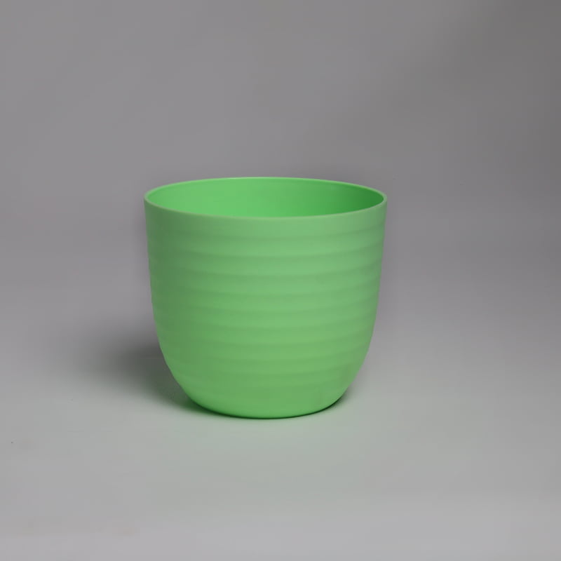 A single green Verona, a round colourful indoor planter made from plastic that you can buy online at Sukham Home, a sustainable furniture, gardening and home decor store in Kolkata, India