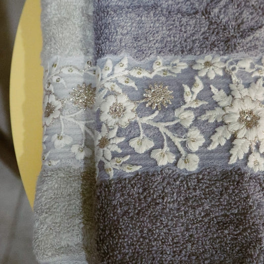 Hand towels with white and gold embroidery from the Grey & Beige Silly-Cuddly, a set of 8 floral embroidered towels you can buy online at Sukham Home, a sustainable furniture, kitchen & dining and home decor store in Kolkata, India