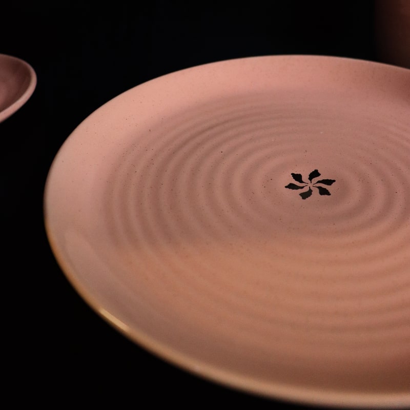 Close up of the Old Rose Ganga Dinner Plate, a pink and 24-karat gold ceramic plate you can buy online at Sukham Home, a sustainable furniture, gardening and home decor store in Kolkata, India