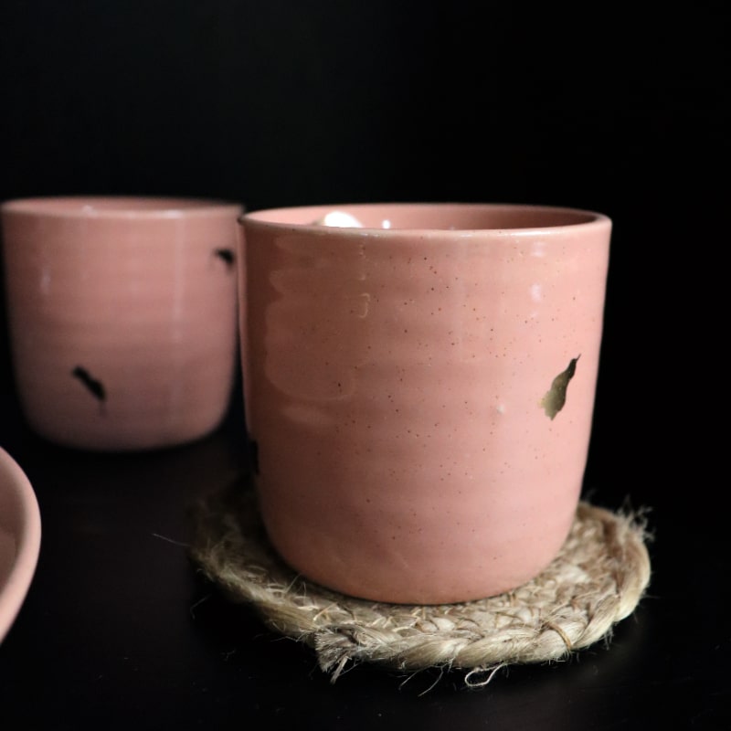 A pair of Old Rose Ganga Kulhad, a pink and 24-karat gold ceramic glass/cup you can buy online at Sukham Home, a sustainable furniture, gardening and home decor store in Kolkata, India