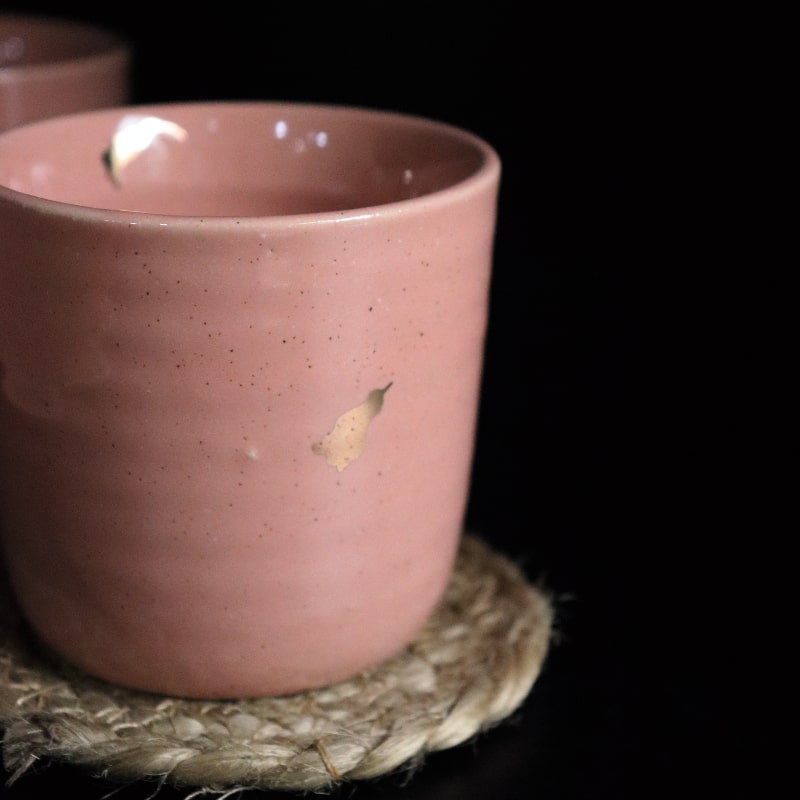 Close up of the texture and gold flakes of the Old Rose Ganga Kulhad, a pink and 24-karat gold ceramic glass/cup you can buy online at Sukham Home, a sustainable furniture, gardening and home decor store in Kolkata, India