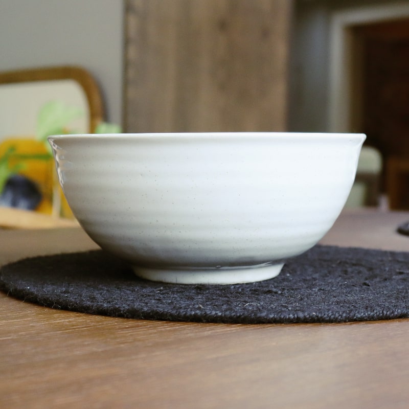 Side view of the Ivory Ganga Serving Bowl, a white and 24-karat gold ceramic serving big bowl you can buy online at Sukham Home, a sustainable furniture, gardening and home decor store in Kolkata, India