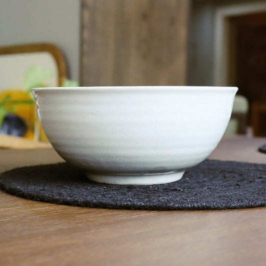 Side view of the Ivory Ganga Serving Bowl, a white and 24-karat gold ceramic serving big bowl you can buy online at Sukham Home, a sustainable furniture, gardening and home decor store in Kolkata, India