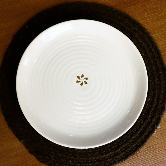 Top view of the Ivory Ganga Dinner Plate, a pure white and 24-karat gold ceramic plate you can buy online at Sukham Home, a sustainable furniture, gardening and home decor store in Kolkata, India