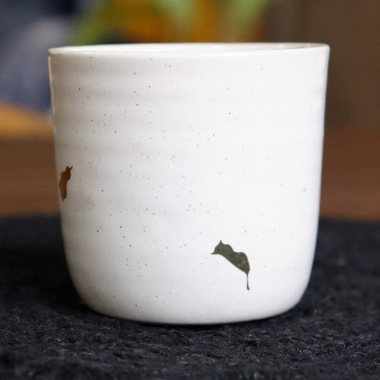 Close up of the Ivory Ganga Kulhad, an pure white and 24-karat gold ceramic cup/glass you can buy online at Sukham Home, a sustainable furniture, gardening and home decor store in Kolkata, India