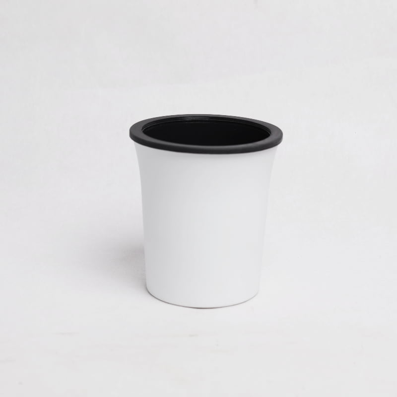 Against a white background, the Oslo, a round white, self watering indoor planter made from plastic that you can buy online at Sukham Home, a sustainable furniture, gardening and home decor store in Kolkata, India