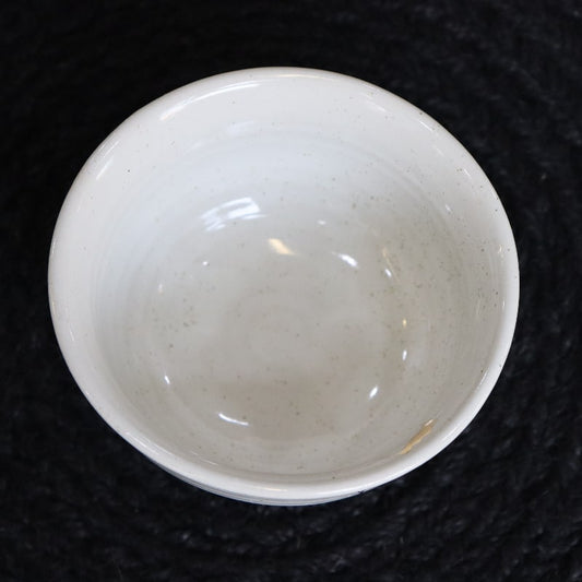 Top view of the Ivory Ganga Small Bowl, a pure white and 24-karat gold ceramic small bowl you can buy online at Sukham Home, a sustainable furniture, gardening and home decor store in Kolkata, India