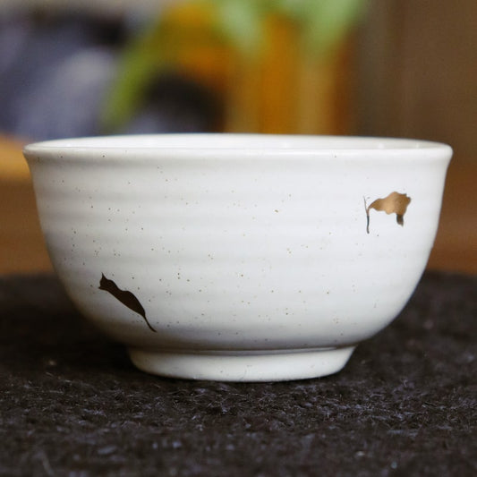 Close up of the textured pattern and gold flakes on the Ivory Ganga Small Bowl, a pure white and 24-karat gold ceramic small bowl you can buy online at Sukham Home, a sustainable furniture, gardening and home decor store in Kolkata, India