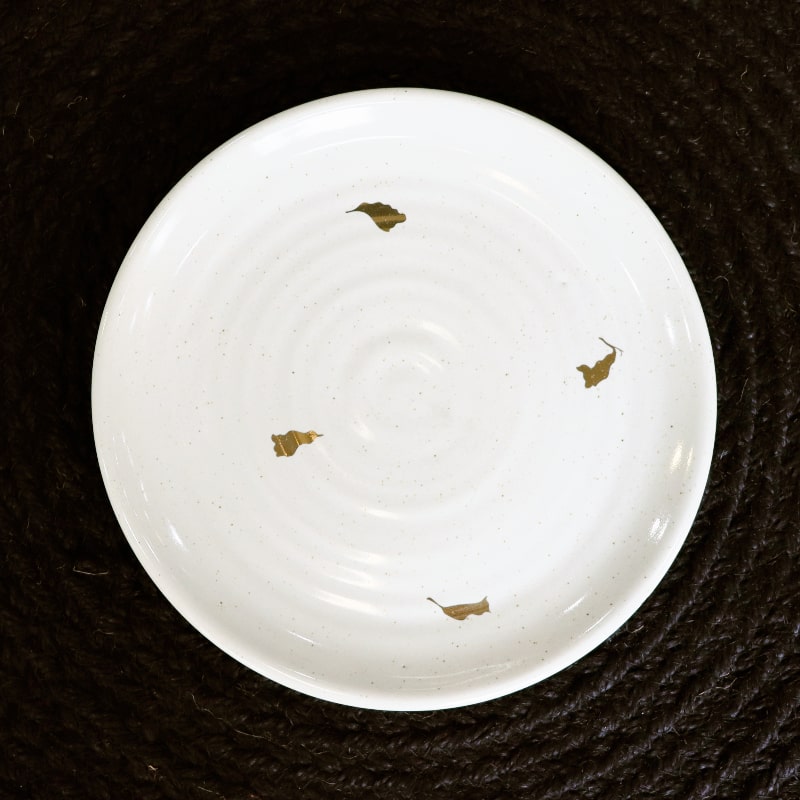 Top view of the Ivory Ganga Quarter Plate, a white and 24-karat gold ceramic small plate you can buy online at Sukham Home, a sustainable furniture, gardening and home decor store in Kolkata, India