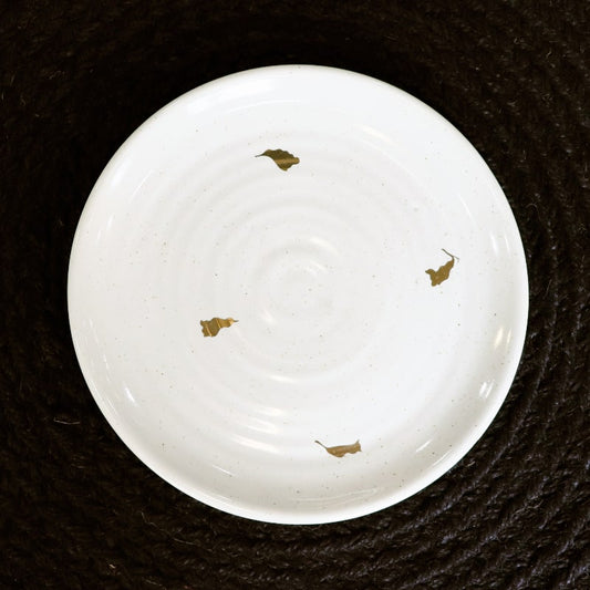 Top view of the Ivory Ganga Quarter Plate, a white and 24-karat gold ceramic small plate you can buy online at Sukham Home, a sustainable furniture, gardening and home decor store in Kolkata, India