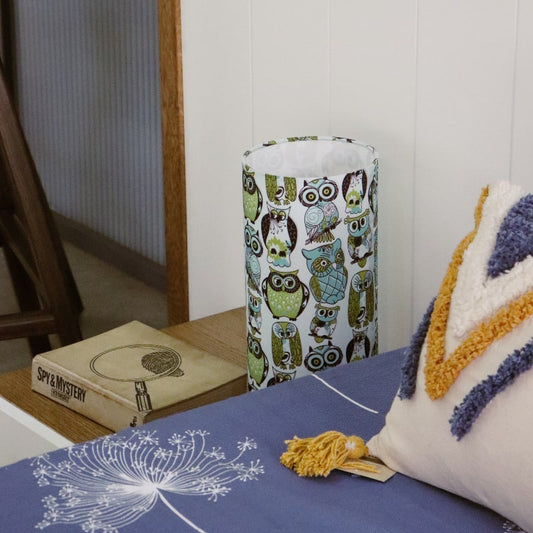 Placed on a bedside table, Wise Owl, a cloth canvas table lamp with many quirky owl designs you can buy online at Sukham Home, a sustainable furniture, kitchen & dining and home decor store in Kolkata, India