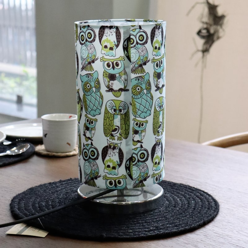 Placed on a table without the light on, Wise Owl, a cloth canvas table lamp with many quirky owl designs you can buy online at Sukham Home, a sustainable furniture, kitchen & dining and home decor store in Kolkata, India