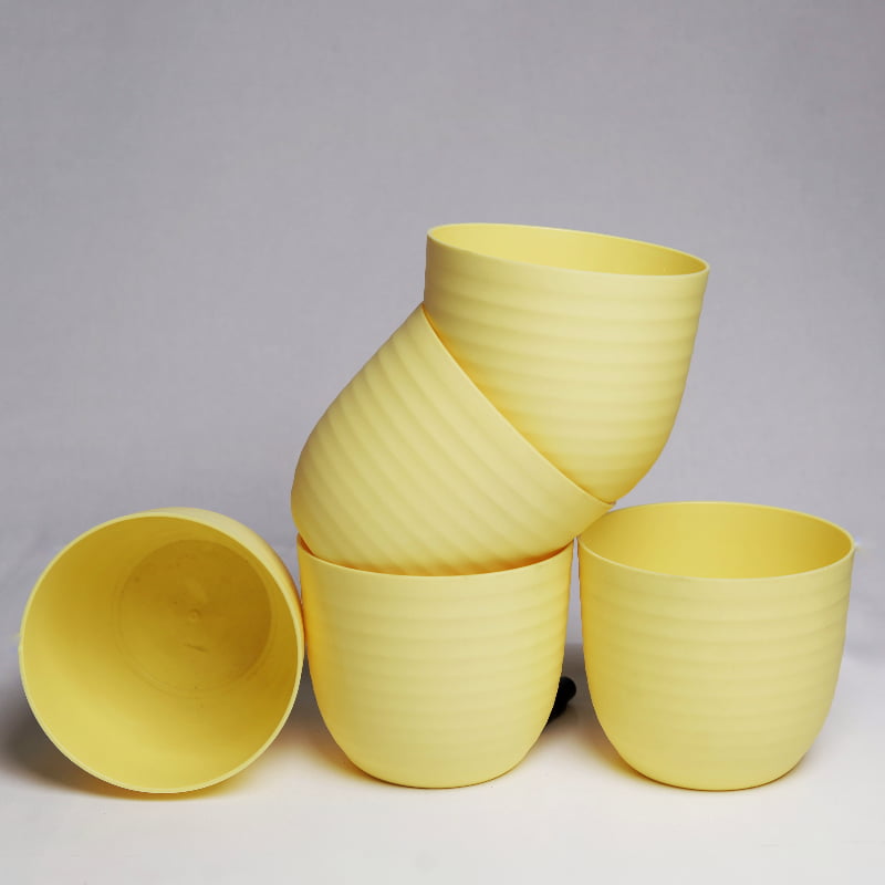 Five pieces of yellow Verona, a round colourful indoor planter made from plastic that you can buy online at Sukham Home, a sustainable furniture, gardening and home decor store in Kolkata, India