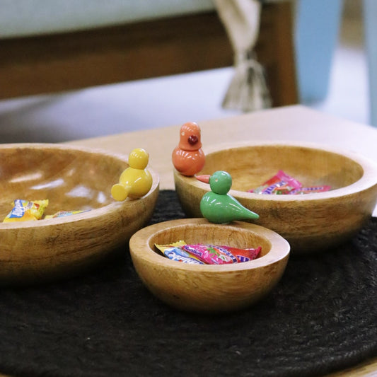 With sweets kept inside, the Birds in Paradise Wooden Bowls, a set of 3 solid wood bowls with sculptures you can buy online at Sukham Home, a sustainable furniture, kitchen & dining and home decor store in Kolkata, India