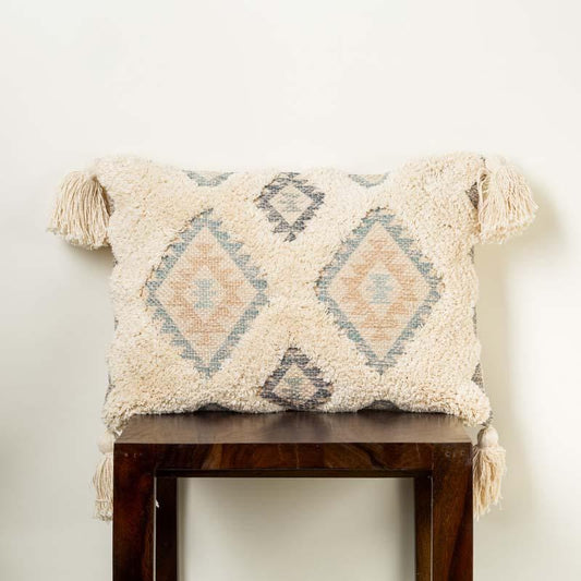 A piece of the Ajanta Cushion, a rectangular tasseled and tufted accent pillow you can buy online at Sukham Home, a sustainable furniture, kitchen & dining and home decor store in Kolkata, India.