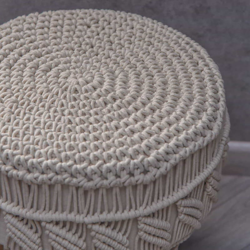 Closeup of the texture and design of the Alabaster Macrame Stool, a white ottoman made from cotton and mango wood, available at Sukham Home, a sustainable furniture, kitchen & dining and home decor store in Kolkata, India