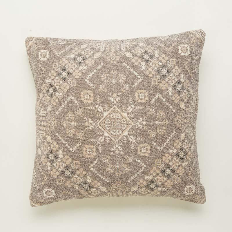 Against white background a piece of the Badami Cushion, a square accent pillow with ethnic prints you can buy online at Sukham Home, a sustainable furniture, kitchen & dining and home decor store in Kolkata, India.