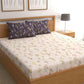 Arranged on a bed, the Bouquets of Joy Bedsheet, a contrasted king size cotton bedsheet you can buy online at Sukham Home, a sustainable furniture, gardening and home decor store in Kolkata, India