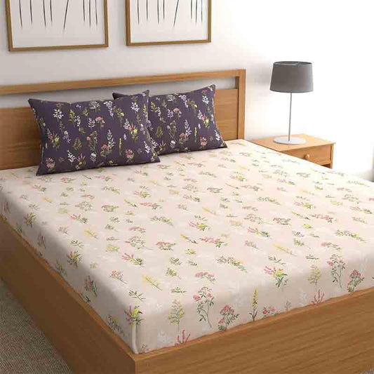 Arranged on a bed, the Bouquets of Joy Bedsheet, a contrasted king size cotton bedsheet you can buy online at Sukham Home, a sustainable furniture, gardening and home decor store in Kolkata, India