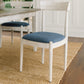 White Bow Dining Chair with a blue padded cushion on a wooden floor