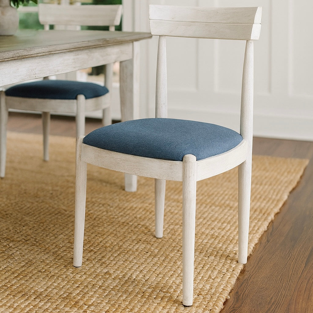White Bow Dining Chair with a blue padded cushion on a wooden floor