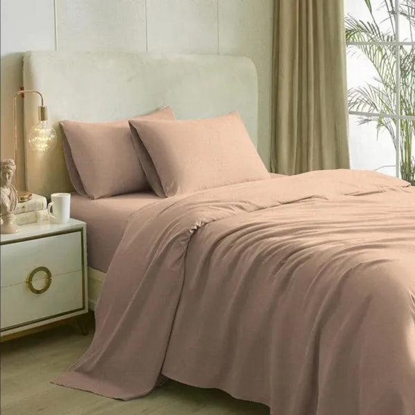 Spread on a bed, the California Dreams, a solid nude rose-pink super king size bedsheet you can buy online at Sukham Home, a sustainable furniture, gardening and home decor store in Kolkata, India