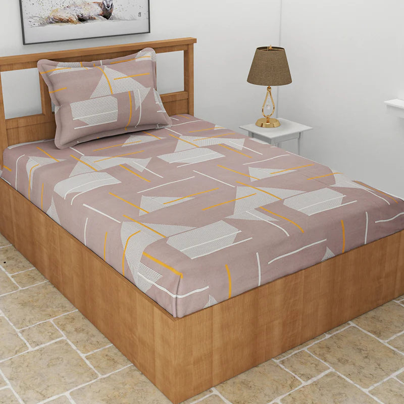 Laid out on a bed, the Dreaming in Sepia, a printed brown geometric queen size bedsheet you can buy online at Sukham Home, a sustainable furniture, gardening and home decor store in Kolkata, India