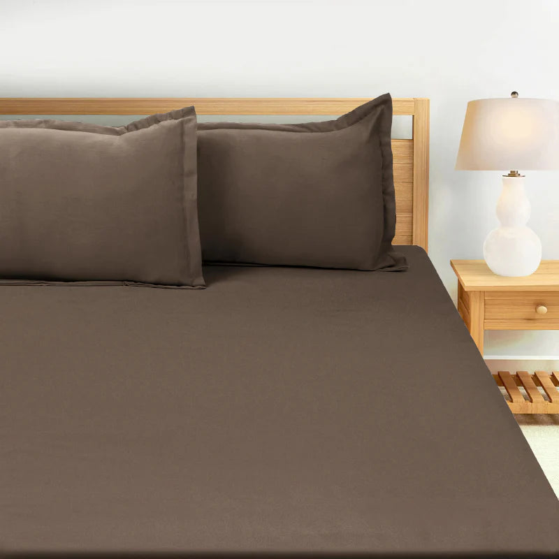 Close up of the bed on which is placed the Espresso Shot, a solid brown super king size bedsheet you can buy online at Sukham Home, a sustainable furniture, gardening and home decor store in Kolkata, India