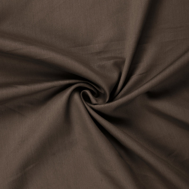 Close up of the material of the Espresso Shot, a solid brown super king size bedsheet you can buy online at Sukham Home, a sustainable furniture, gardening and home decor store in Kolkata, India