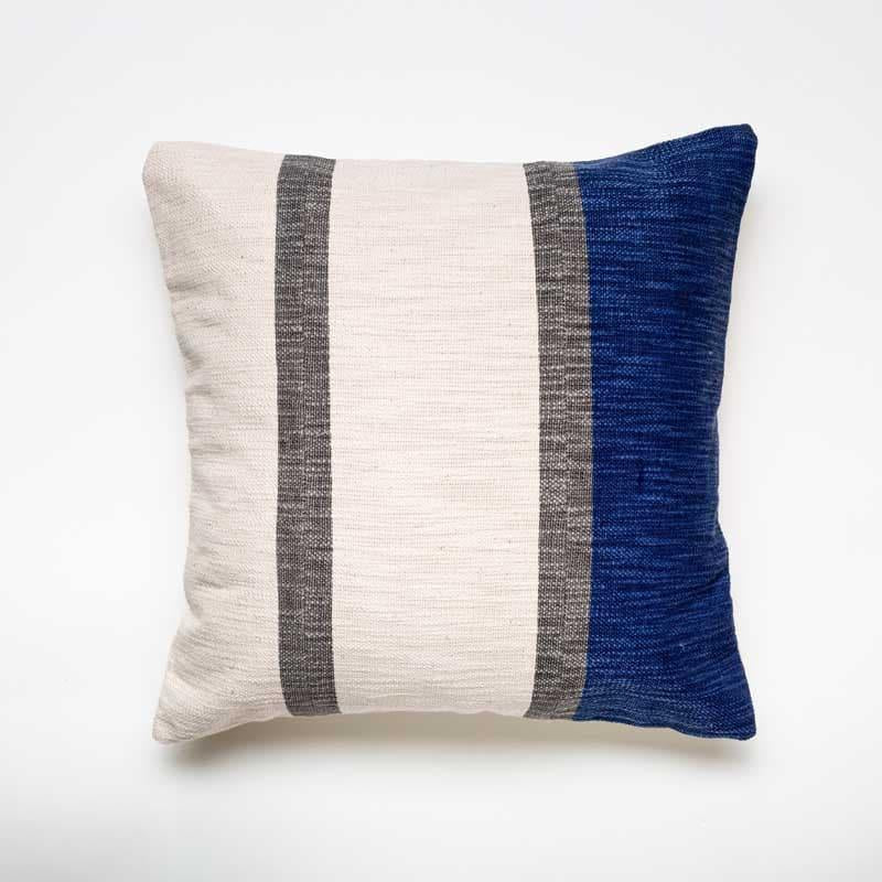 Against a white background, the Inked in Indigo Cushion, a square navy blue and white and brown striped accent pillow you can buy online at Sukham Home, a sustainable furniture, kitchen & dining and home decor store in Kolkata, India