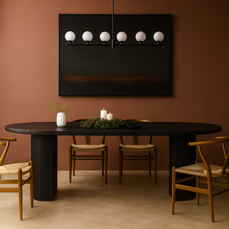 Dining room with a black oval table and chairs against a brown wall.
