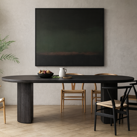 Dining room with a black oval table and chairs, featuring a large black painting on the wall.