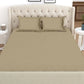 Front the front, spread out on a bed, the Over The Taupe, a solid beige-brown super king size bedsheet you can buy online at Sukham Home, a sustainable furniture, gardening and home decor store in Kolkata, India