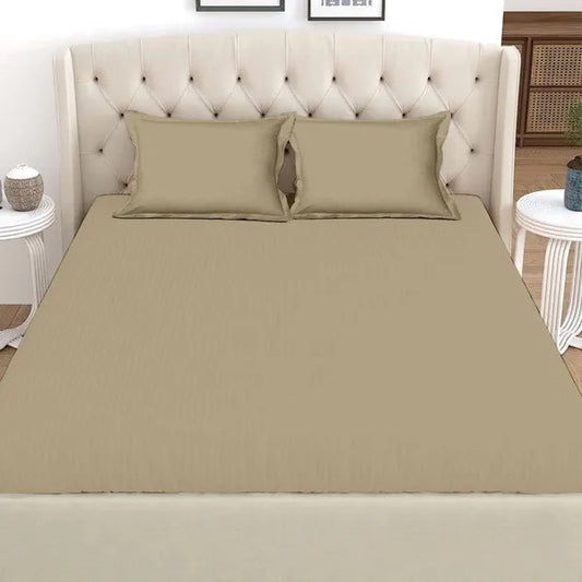 Front the front, spread out on a bed, the Over The Taupe, a solid beige-brown super king size bedsheet you can buy online at Sukham Home, a sustainable furniture, gardening and home decor store in Kolkata, India