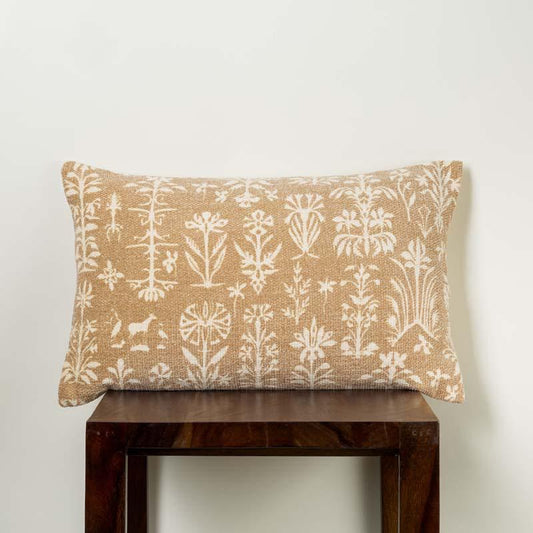 The Panchatantra Tales Cushion, a rectangle accent pillow with indie folk patterns, kept on a stool, you can buy online at Sukham Home, a sustainable furniture, kitchen & dining and home decor store in Kolkata, India.