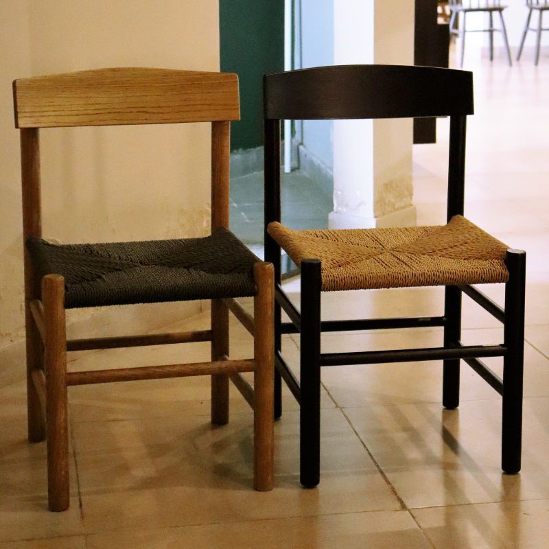 The Oak Natural and Ash Charcoal finish People's, a solid oak wood chair with a danish cord seat you can buy online at Sukham Home, a sustainable furniture and home decor store in Kolkata, India