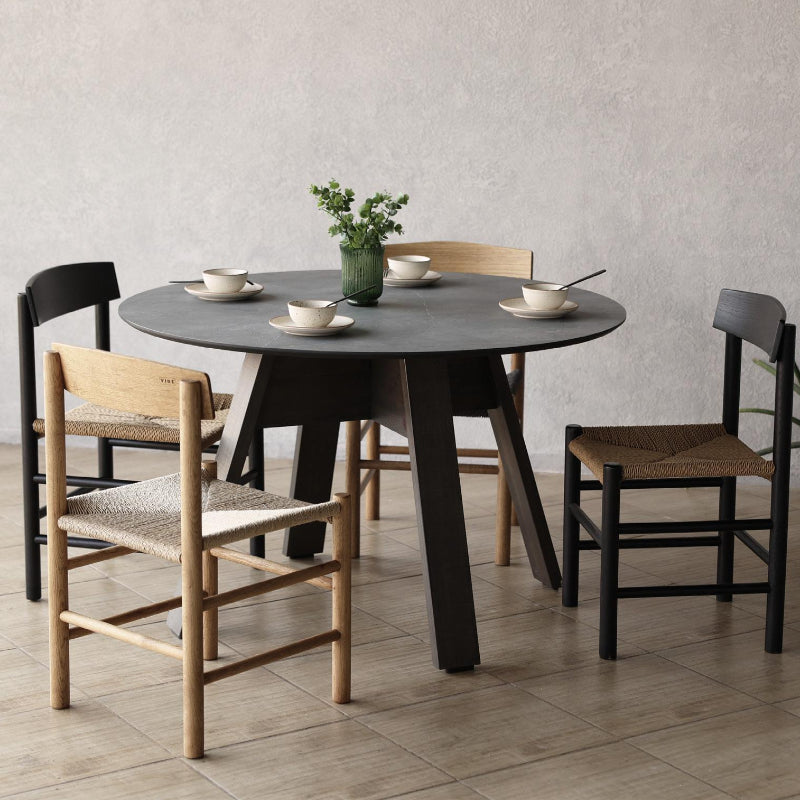 Full moon dining table with People's chairs in a room with a plant
