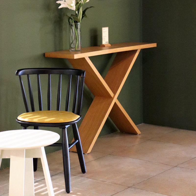 Front view of the Ash Charcoal Perch Chair, a solid wood Windsor dining seat you can buy online at Sukham Home, a sustainable furniture and home decor store in Kolkata, India