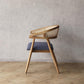 Pie Dining Chair with woven backrest and upholstered seat against a plain wall.