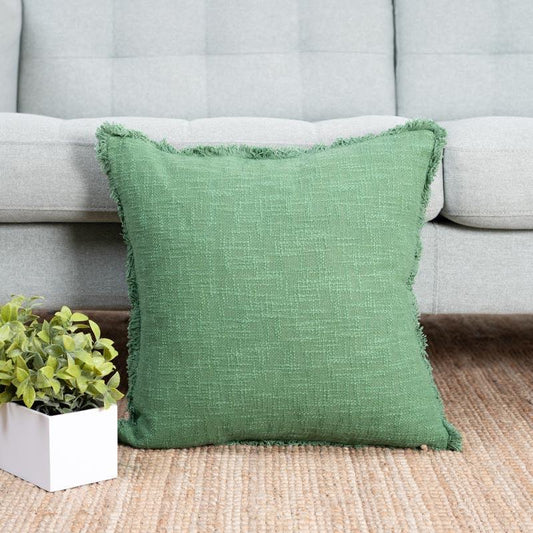 Kept against a sofa, the Sage Textured Cushion, a square accent pillow with joyful colour pattern you can buy online at Sukham Home, a sustainable furniture, kitchen & dining and home decor store in Kolkata, India.