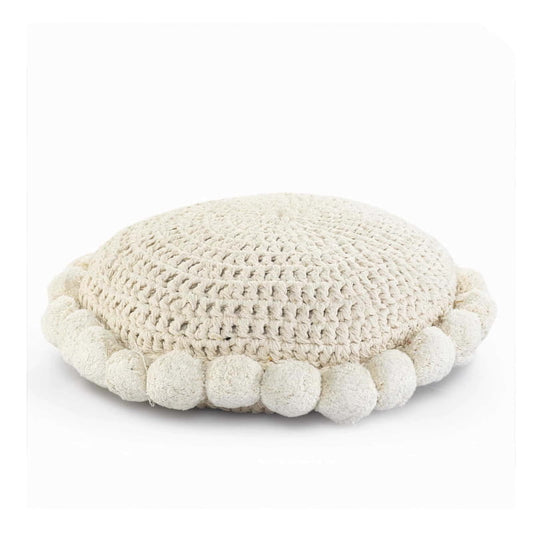 A side view of the Snowball Crochet Cushion, a round accent pillow with crochet and fluffy pom poms which you can buy online at Sukham Home, a sustainable furniture, kitchen & dining and home decor store in Kolkata, India.