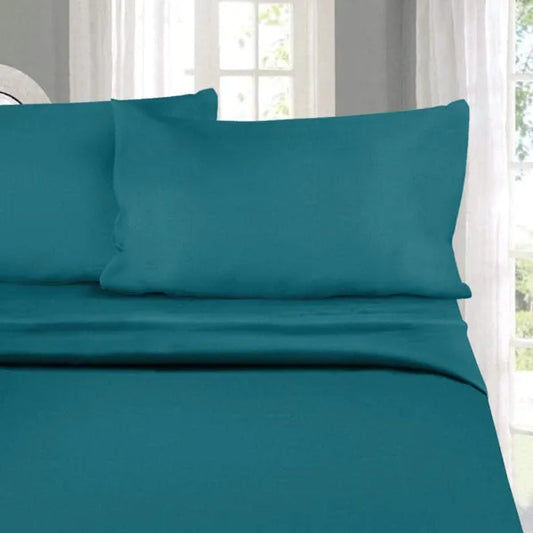 Pillows and sheet of the Teal-Licious, a solid blue-green super king size bedsheet you can buy online at Sukham Home, a sustainable furniture, gardening and home decor store in Kolkata, India